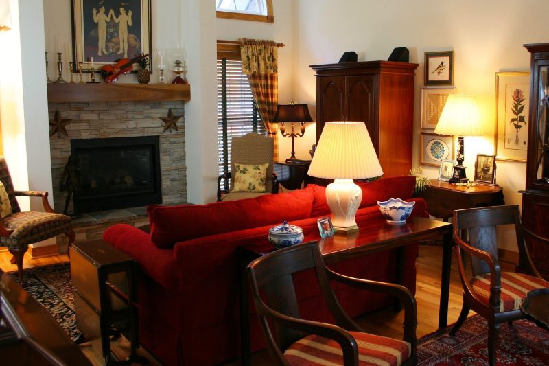 Warm living room with classic furniture and a fireplace, creating a cozy atmosphere.